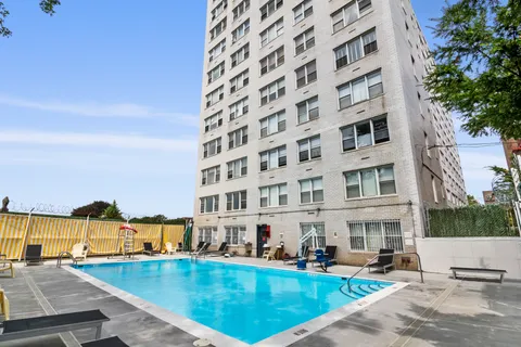 a view of a swimming pool with outdoor seating