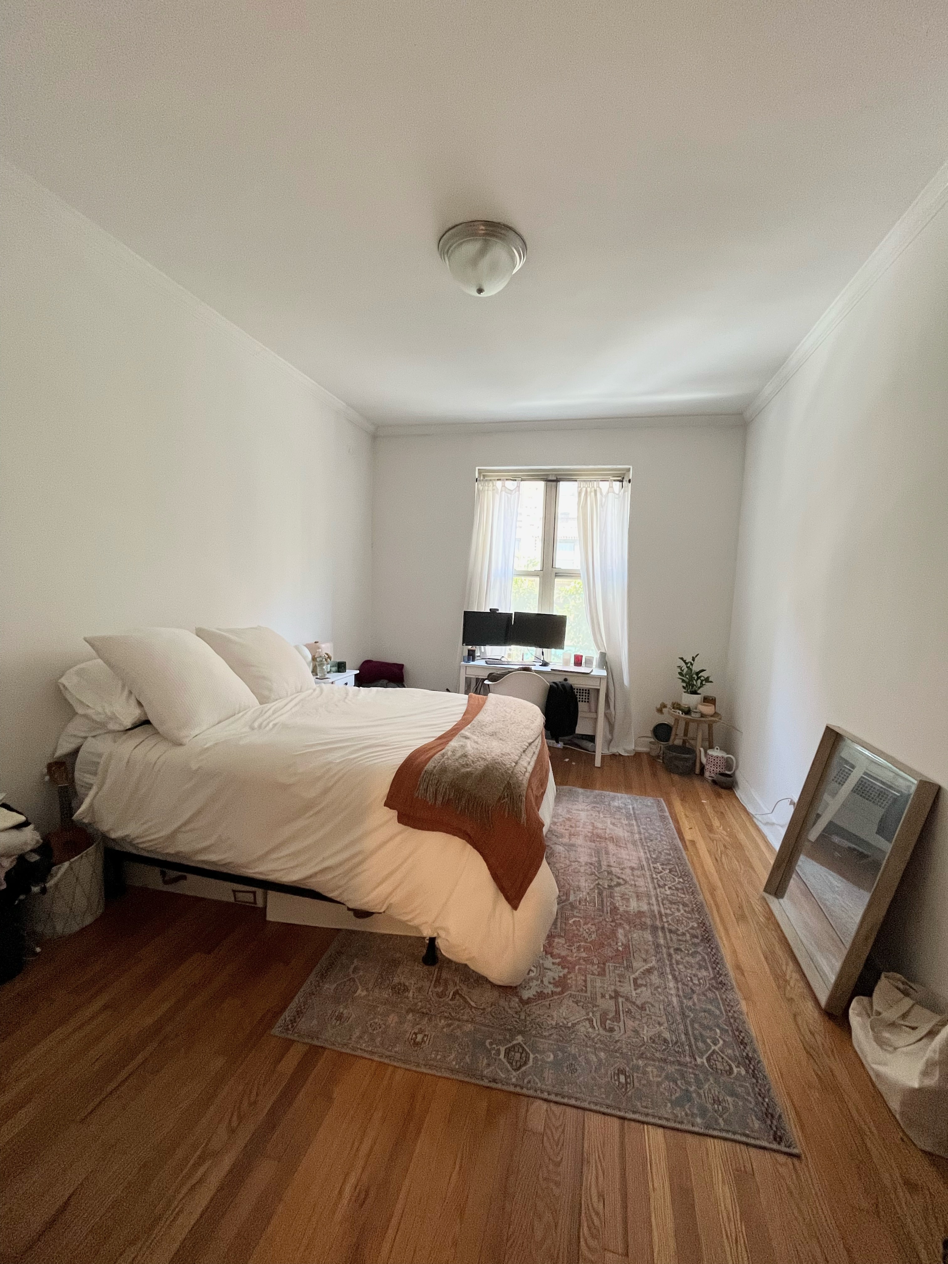 330 East 58th Street, Unit 4A Manhattan, NY 10022 - Photo 5 of 11 a bedroom with a bed and wooden floor
