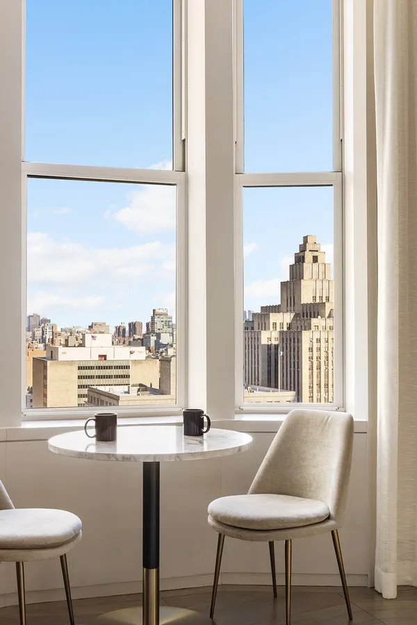 a view of a dining room with furniture window and outside view