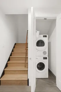 a view of a storage and utility room with a washer dryer