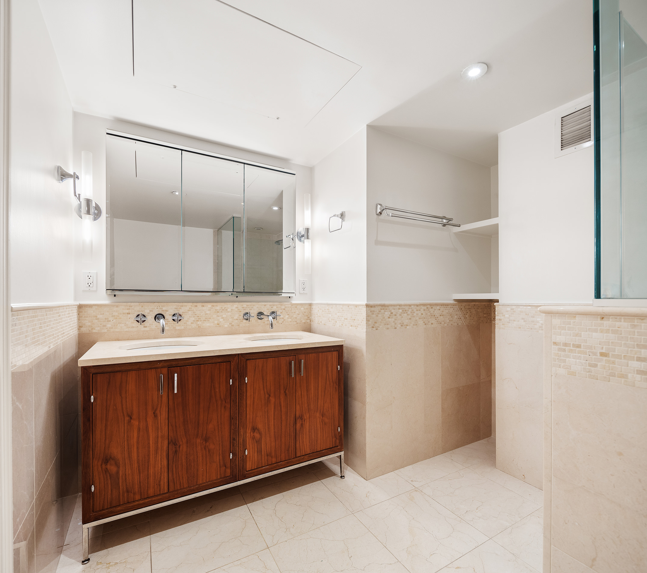 200 East 66th Street, Unit D1203 Manhattan, NY 10065 - Photo 6 of 24 a bathroom with a sink and mirror
