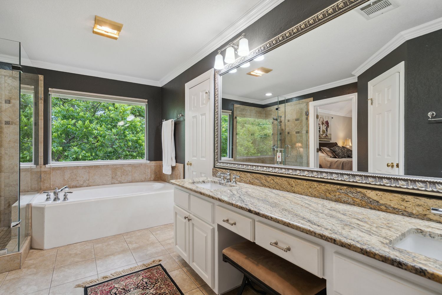 a bath room with a sink and large window