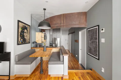 a dining room with furniture and a chandelier