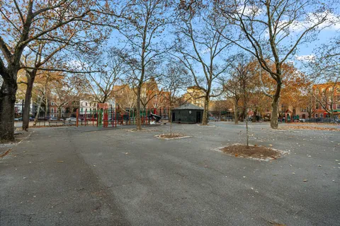 a view of road with with large trees