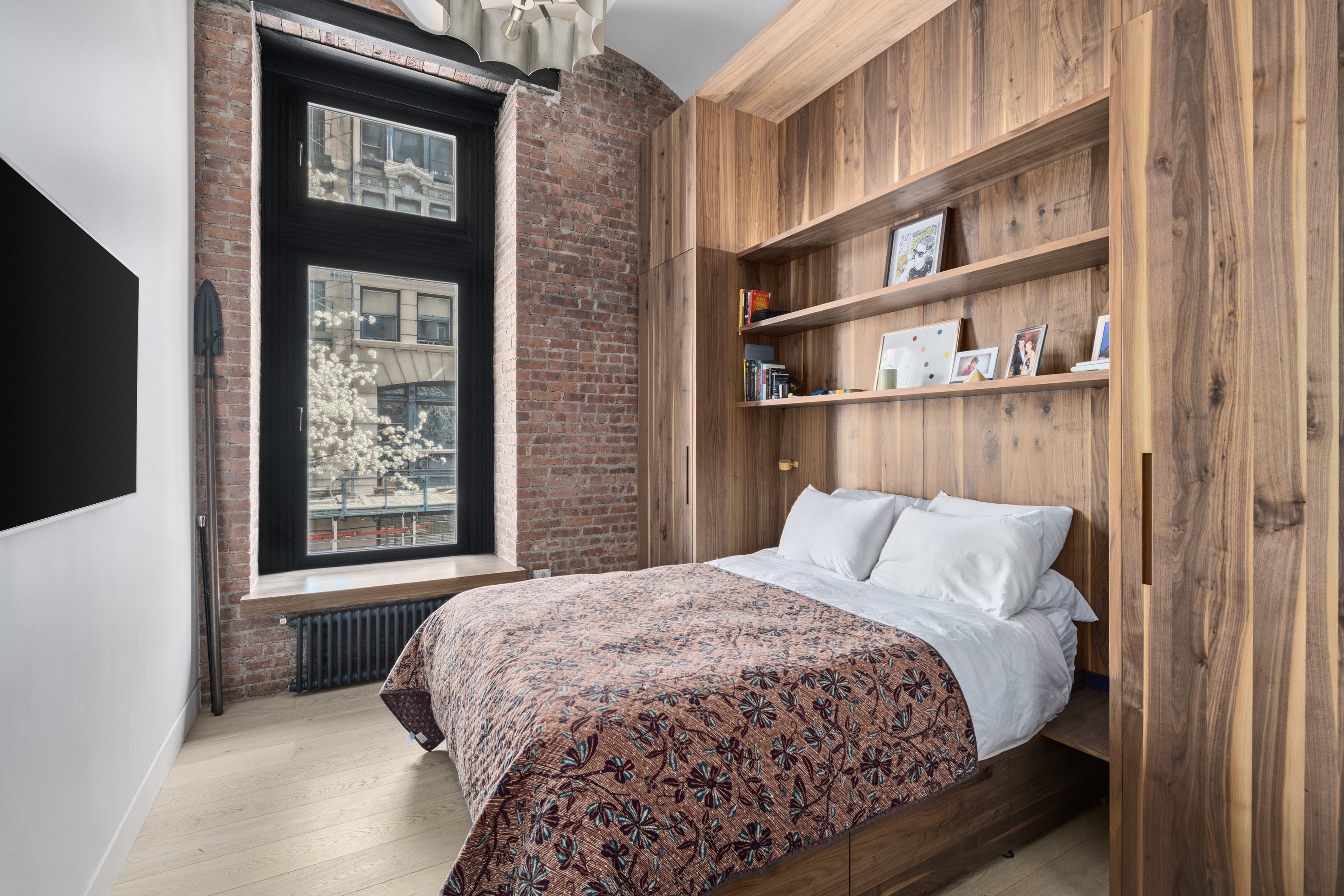 1 Great Jones St, Unit 2B Manhattan, NY 10012 - Photo 7 of 12 a bed sitting in a bedroom next to a window