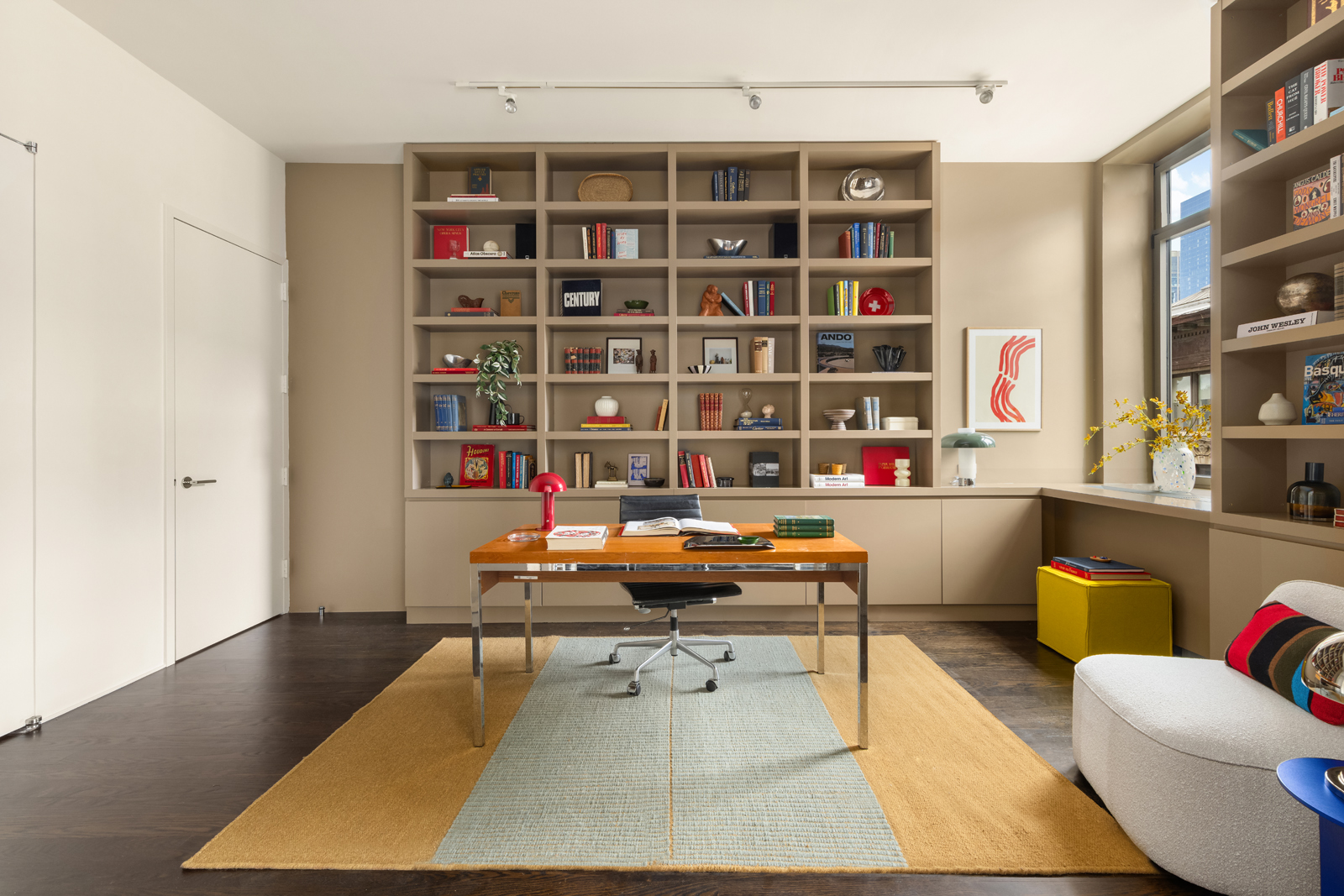 252 7th Avenue, Unit 14G Manhattan, NY 10001 - Photo 6 of 20 a reading room with furniture and a book shelf