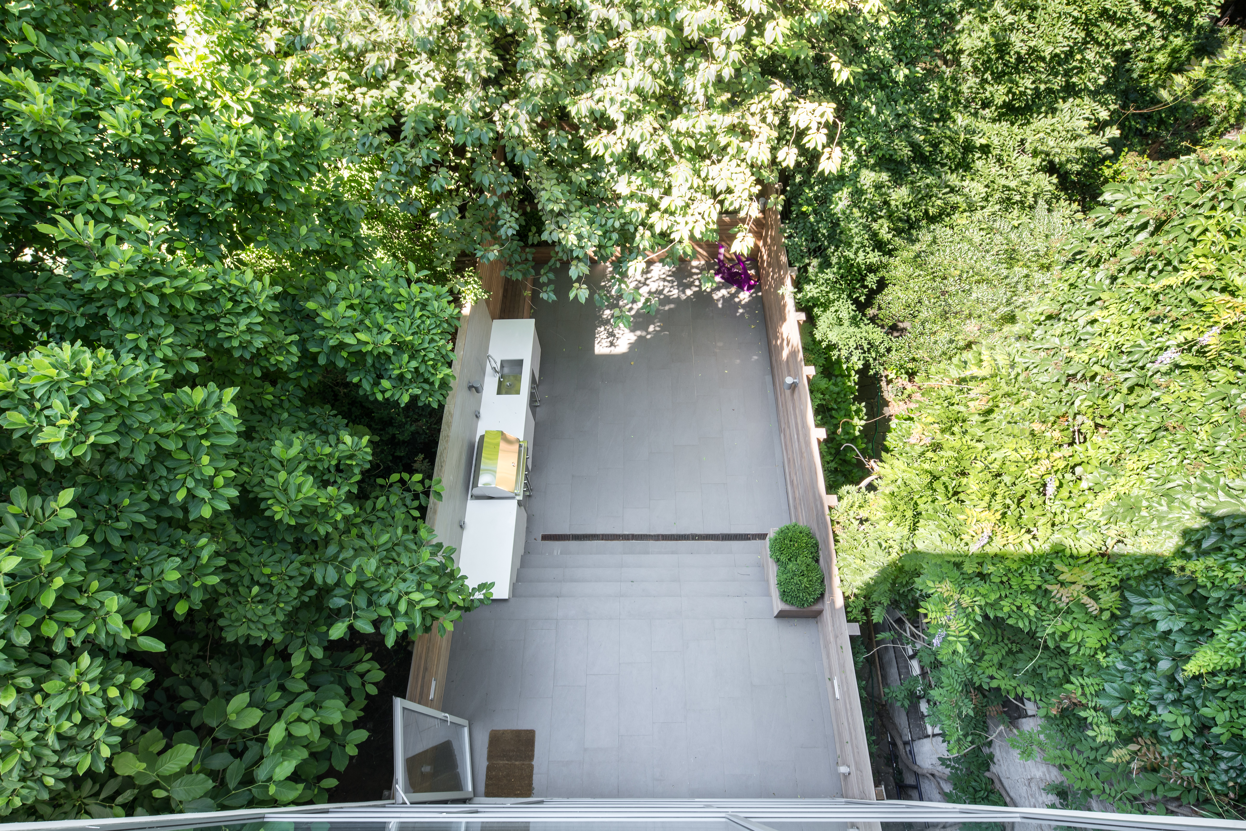 450 West 25th Street Manhattan, NY 10001 - Photo 14 of 16 an aerial view of a house with a yard and large trees