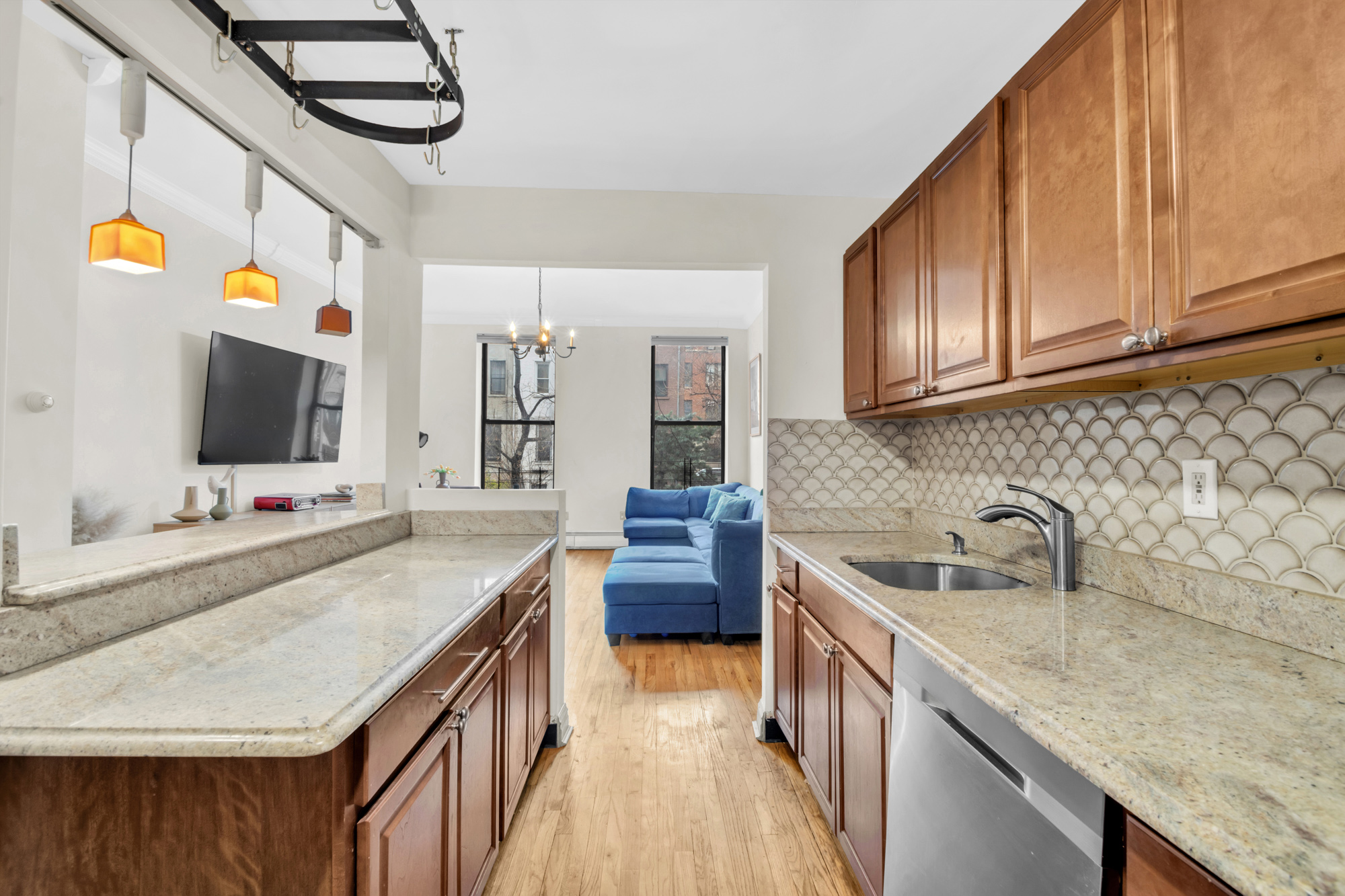 137 West 126th Street, Unit 1 Manhattan, NY 10027 - Photo 4 of 12 a kitchen with stainless steel appliances granite countertop a sink and a stove