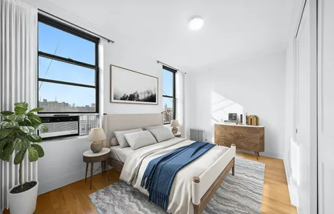 a bedroom with a bed and a potted plant