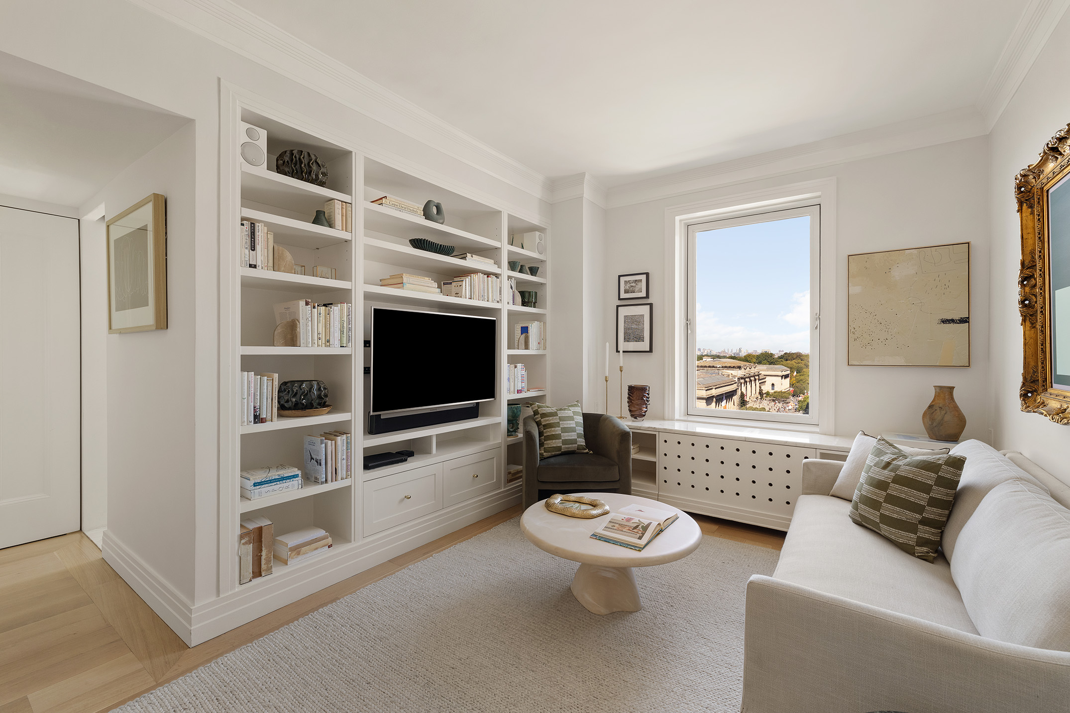 969 5th Avenue, Unit 14 Manhattan, NY 10075 - Photo 10 of 17 a living room with furniture and a flat screen tv