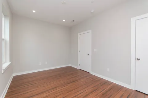 a view of room with wooden floor and white walls