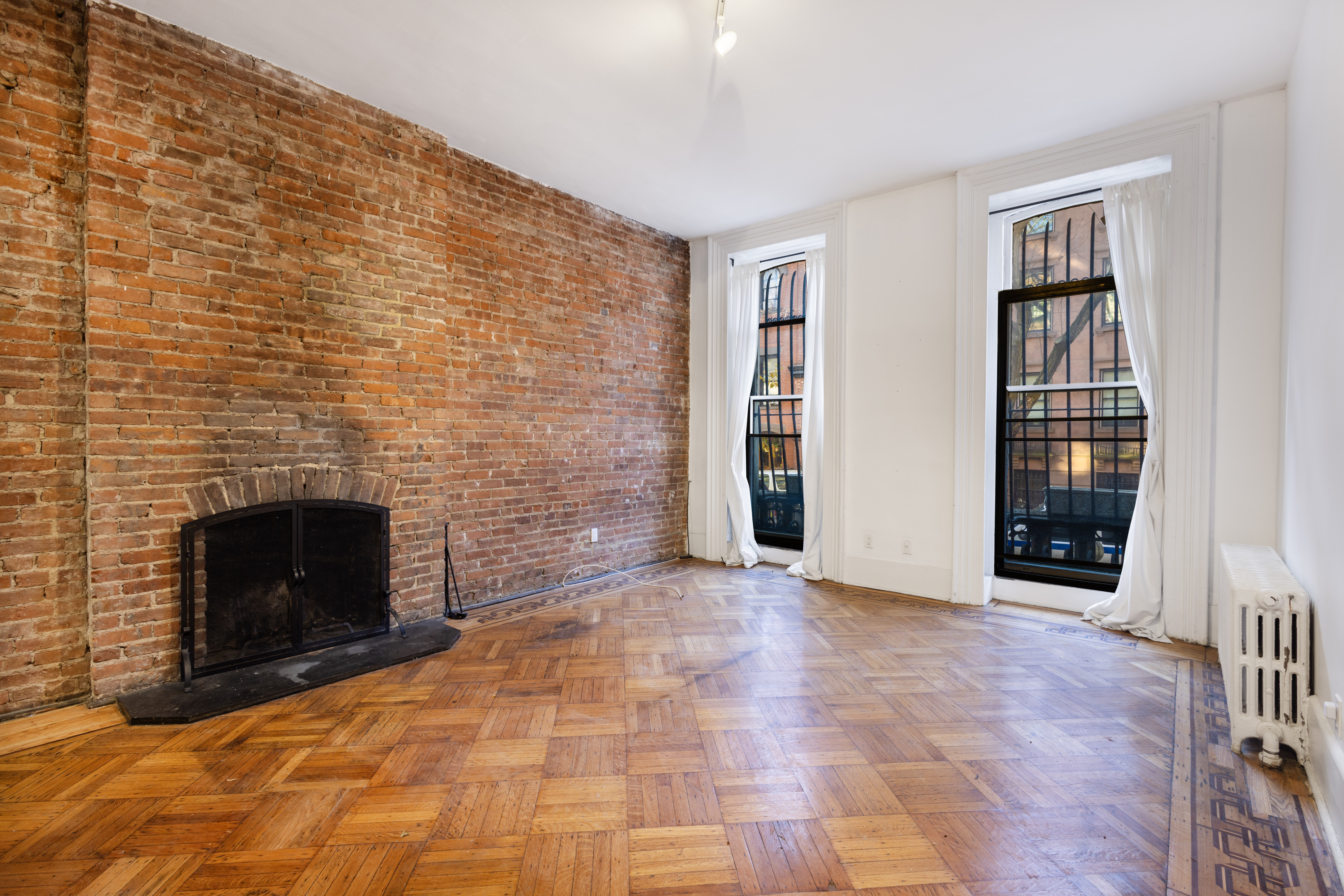 145 State Street, Unit 1 Brooklyn, NY 11201 - Photo 2 of 12 a view of empty room with a fireplace and a window