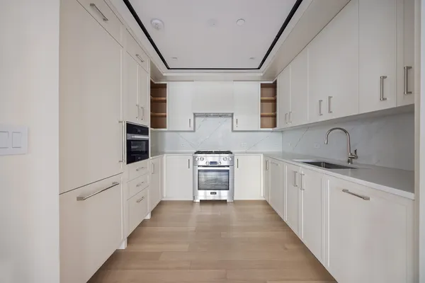 a kitchen with granite countertop a sink and cabinets