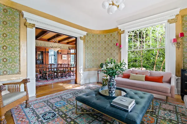 a living room with furniture and a potted plant
