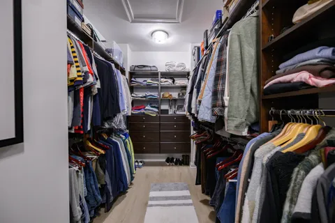 a view of walk in closet with clothes