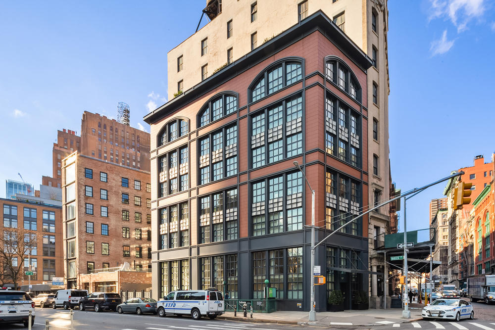 137 Franklin Street, Unit 1 Manhattan, NY 10013 - Photo 24 of 25 a front view of a building with lot of cars and trees