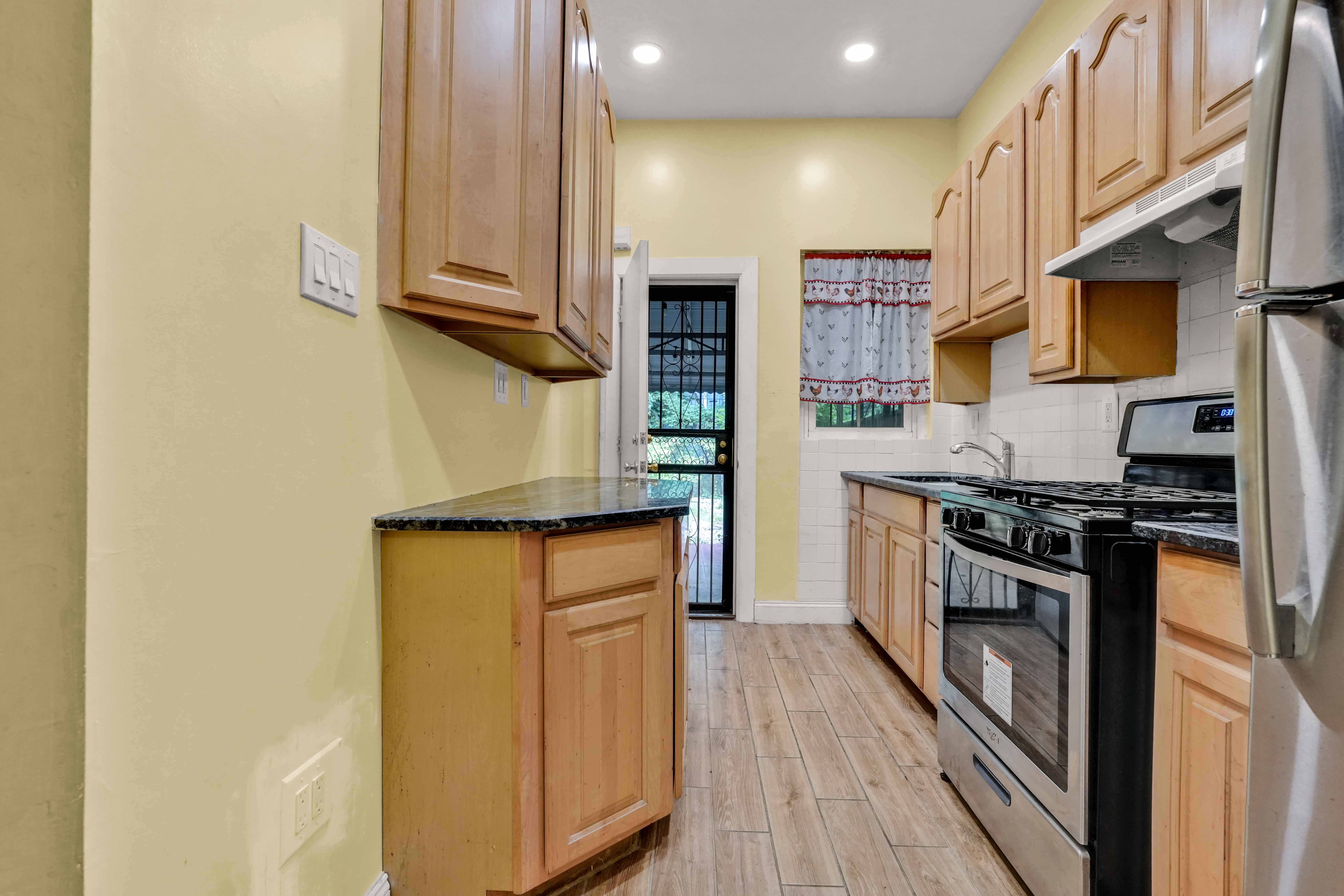 278 Lefferts Avenue Brooklyn, NY 11225 - Photo 34 of 56 a kitchen with stainless steel appliances granite countertop a stove and a refrigerator