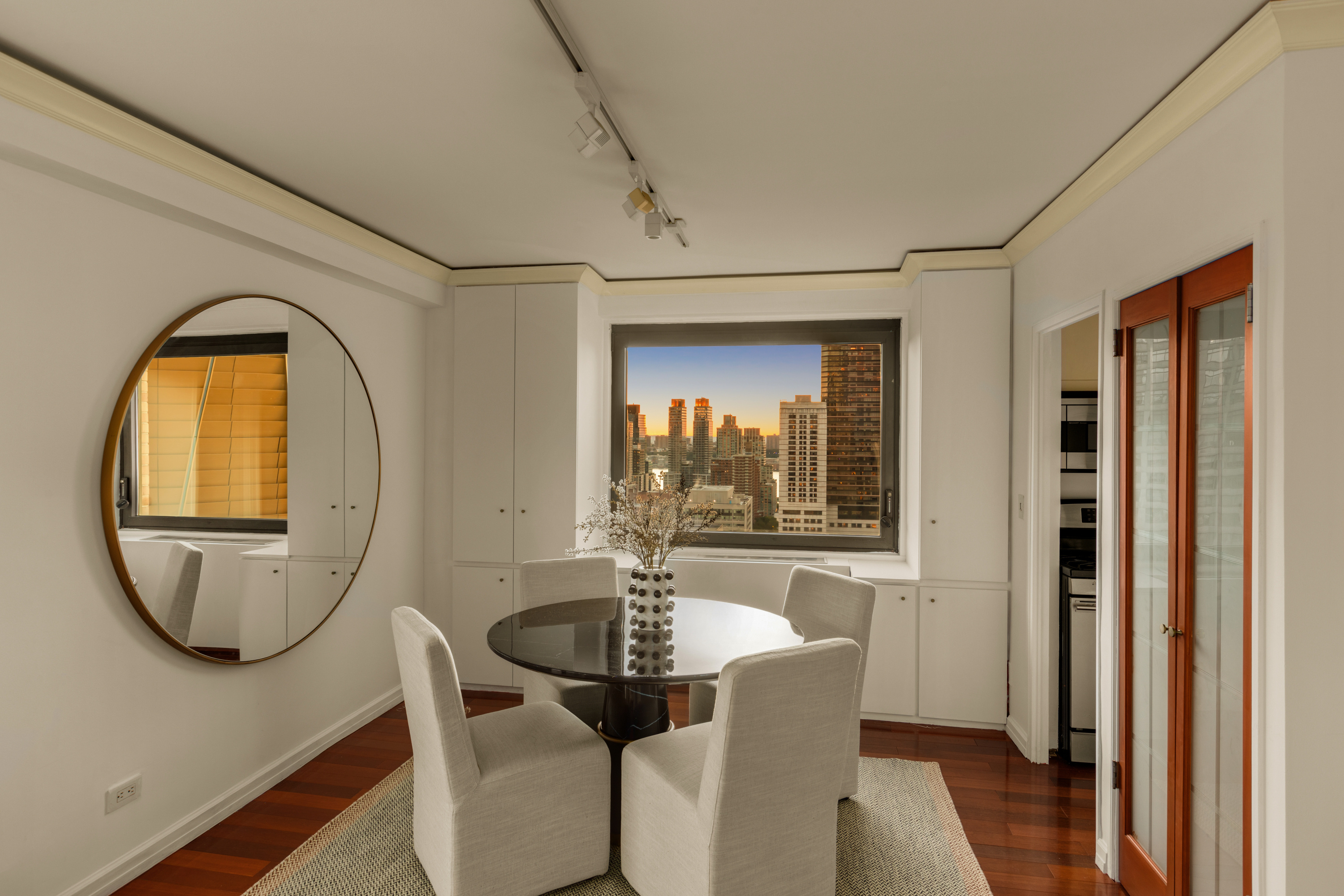 10 West 66th Street, Unit 29E Manhattan, NY 10023 - Photo 17 of 39 a dining room with furniture and a window