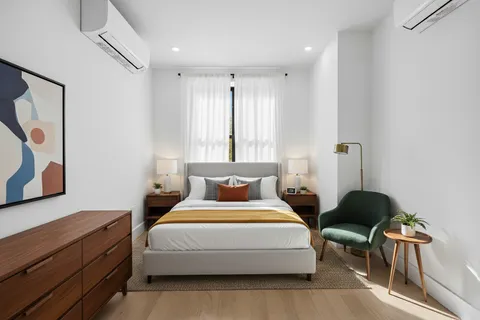 a bedroom with a bed and a chair