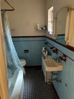a bedroom with a bed and a dresser in it