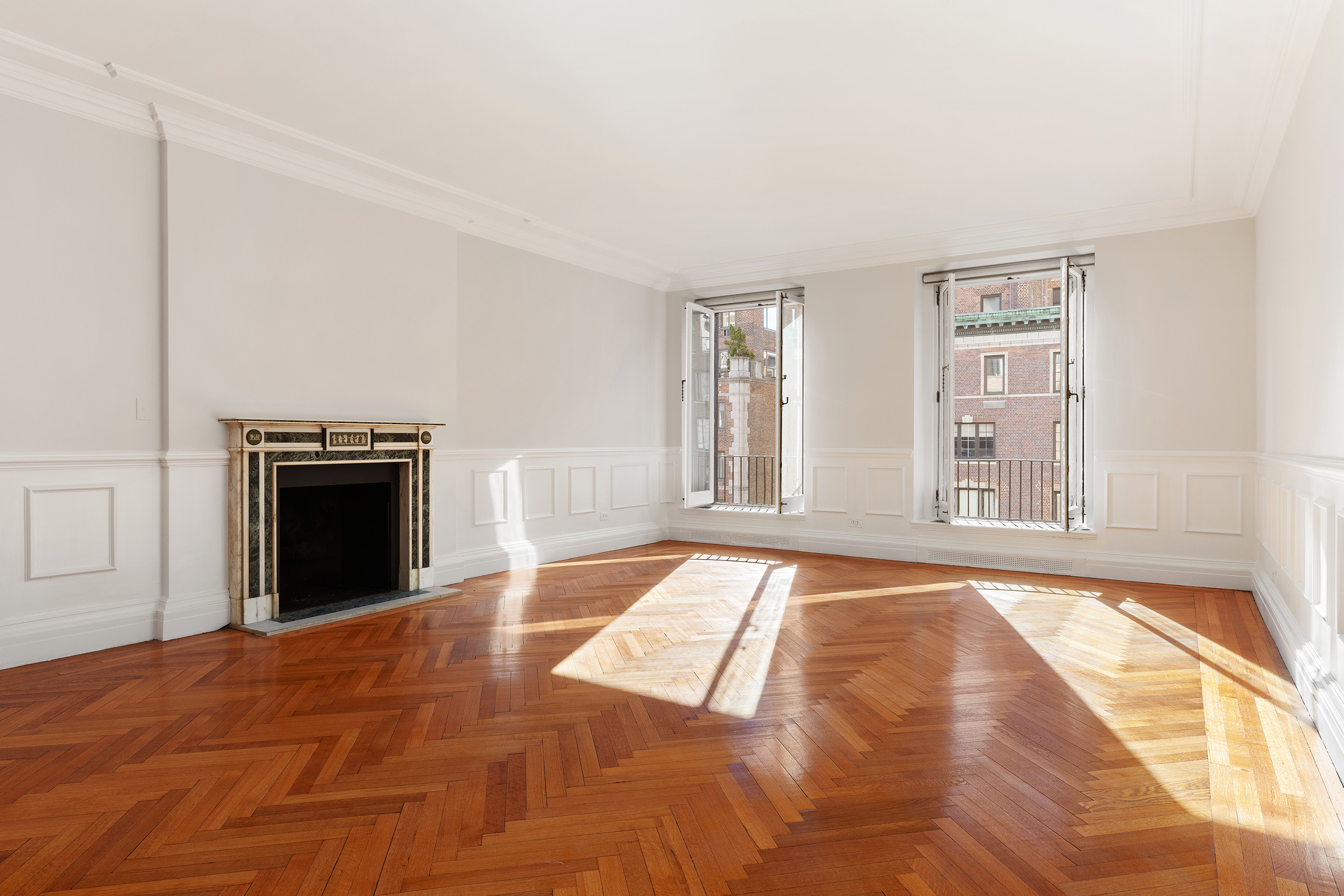 447 East 57th Street, Unit 14 Manhattan, NY 10022 - Photo 2 of 26 a view of an empty room with a fireplace and a window