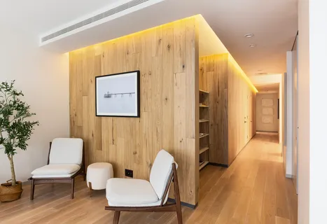 a view of a hallway with furniture and wooden floor