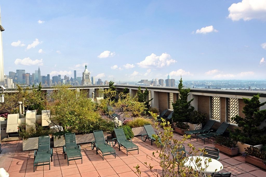 60 East 8th Street, Unit 10E Manhattan, NY 10003 - Photo 11 of 13 a view of a terrace with chairs and potted plants