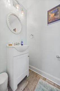 a bathroom with a sink mirror vanity and toilet
