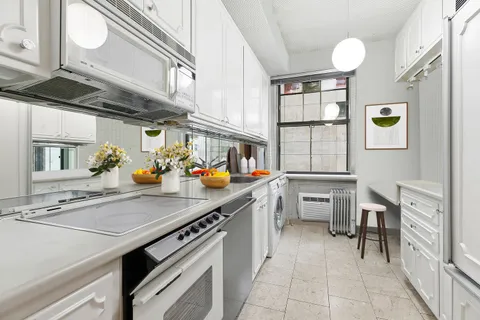 a kitchen that has a lot of cabinets in it