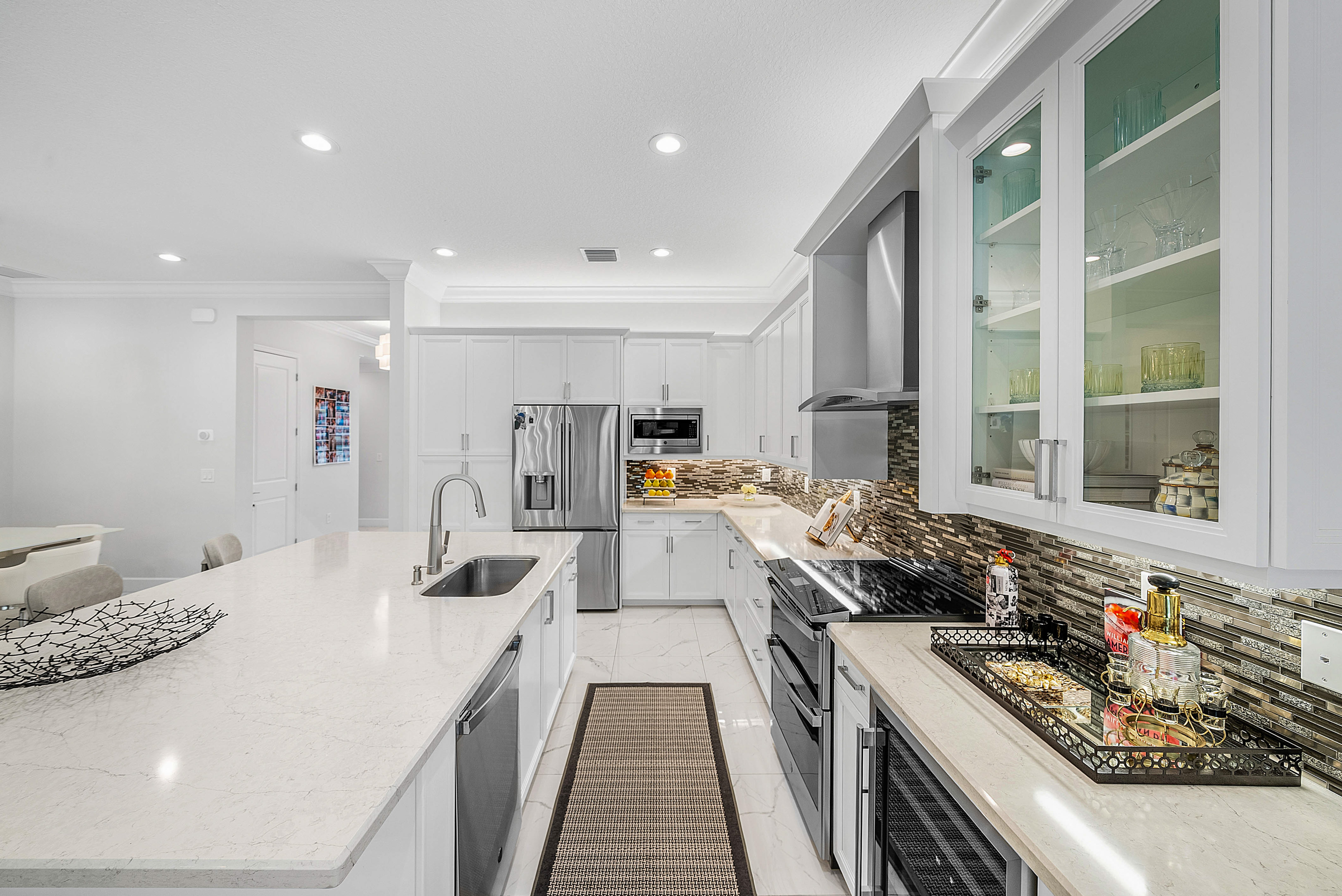 13172 Whistler Mountain Road Delray Beach, FL 33446 - Photo 13 of 38 a kitchen with stainless steel appliances a sink stove and cabinets