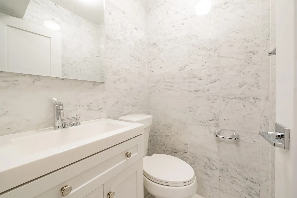 a bathroom with a sink a toilet and vanity