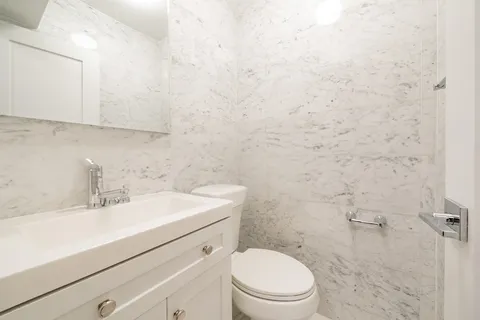 a bathroom with a sink a toilet and vanity