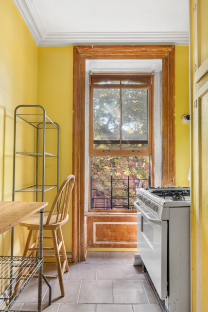 419 Clermont Avenue Brooklyn, NY 11238 - Photo 9 of 14 a living room with a table and chairs