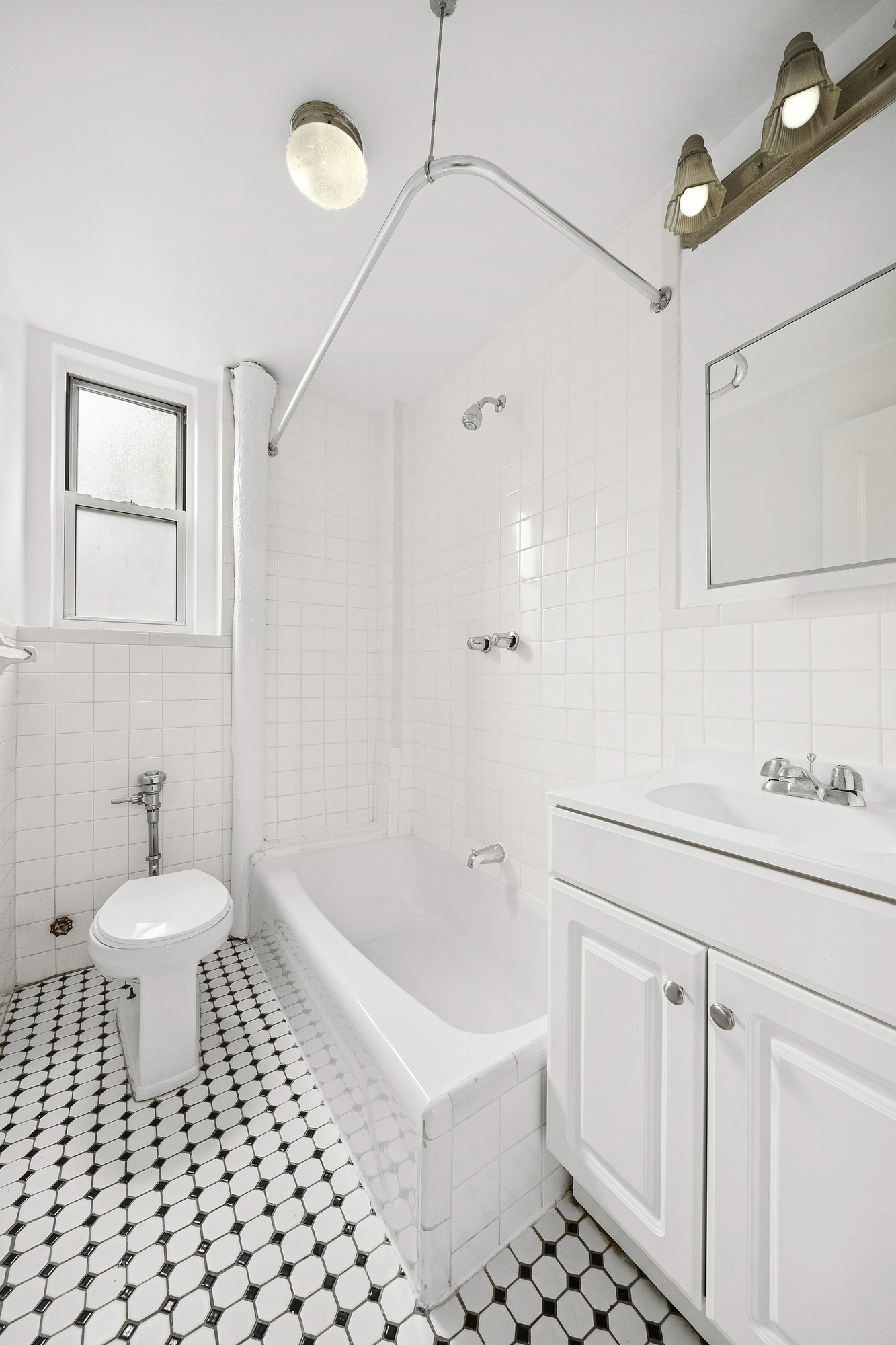 123 Waverly Place, Unit 2D Manhattan, NY 10011 - Photo 4 of 6 a bathroom with a sink a toilet and a shower