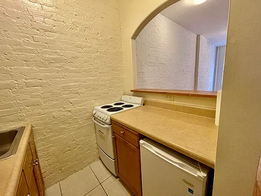 1105 1st Avenue, Unit 9 Manhattan, NY 10065 - Photo 5 of 8 a utility room with a sink