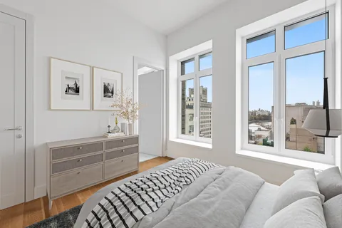 a living room with furniture cabinets and a window