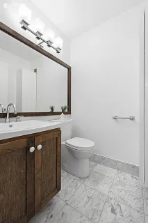 a bathroom with a sink a toilet and mirror