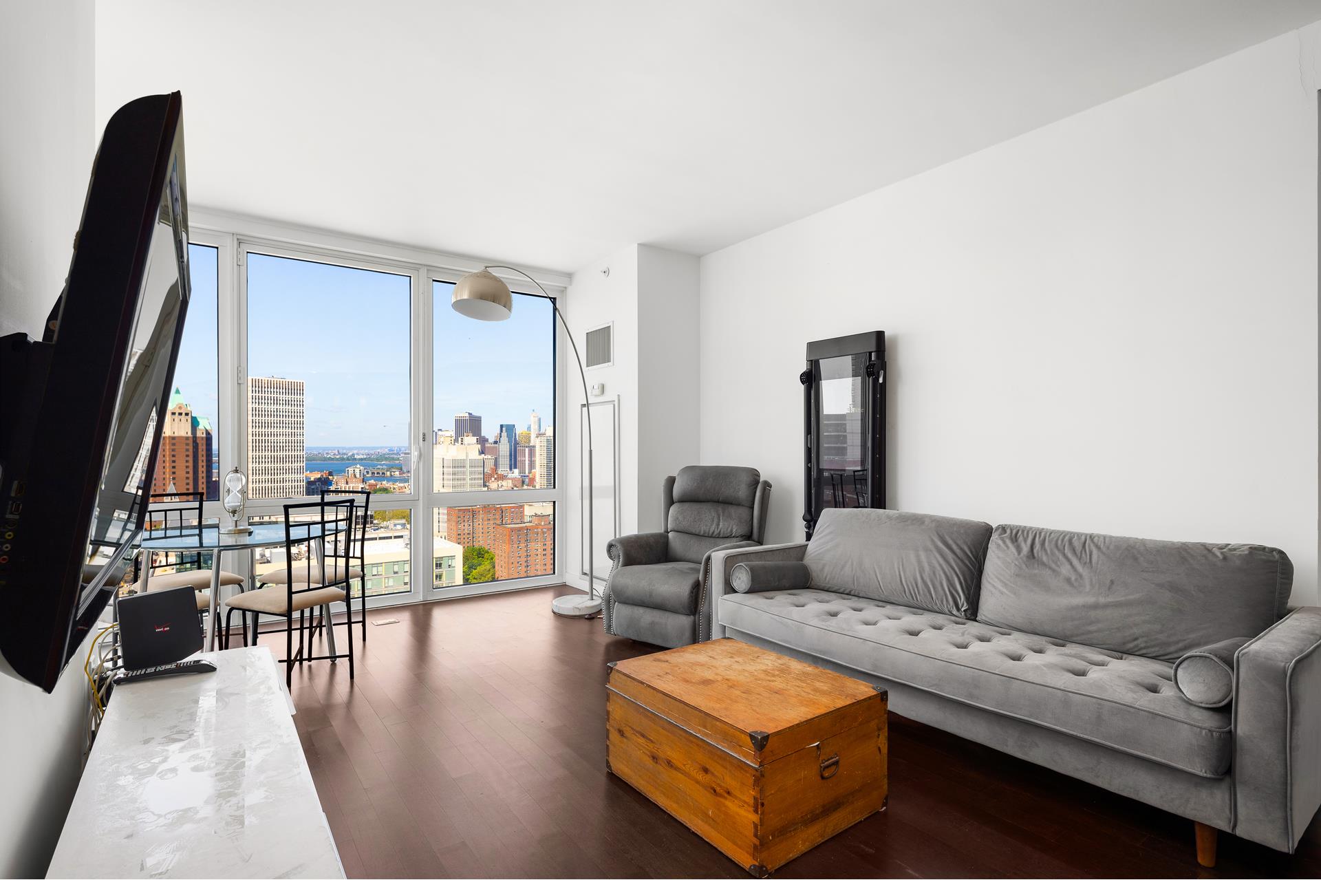 306 Gold Street, Unit 31E Brooklyn, NY 11201 - Photo 3 of 15 a living room with furniture and a flat screen tv