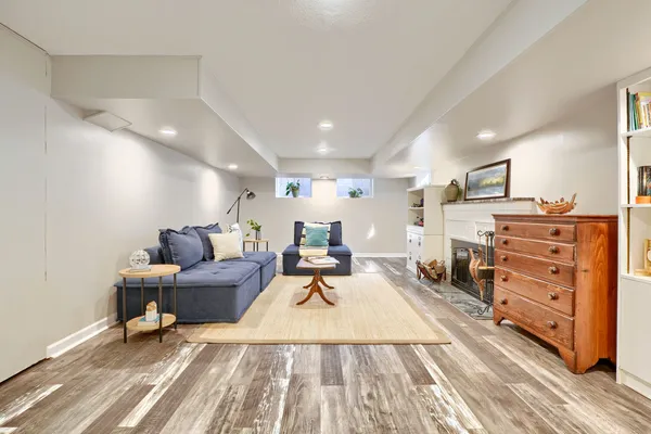 a living room with furniture and a wooden floor