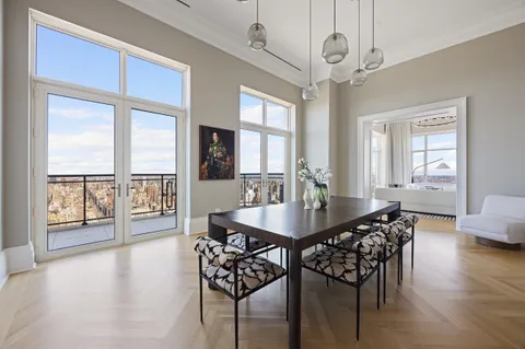 a view of a dining room with furniture wooden floor and chandelier
