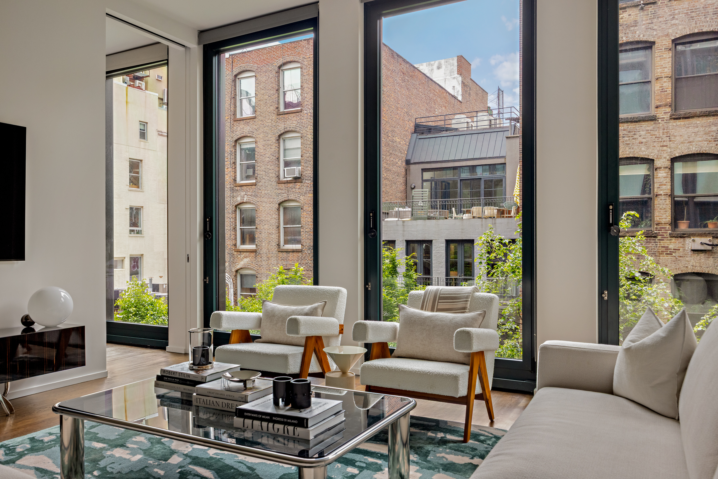 40 Bond Street, Unit 6D Manhattan, NY 10012 - Photo 3 of 23 a living room with furniture fireplace and a large window