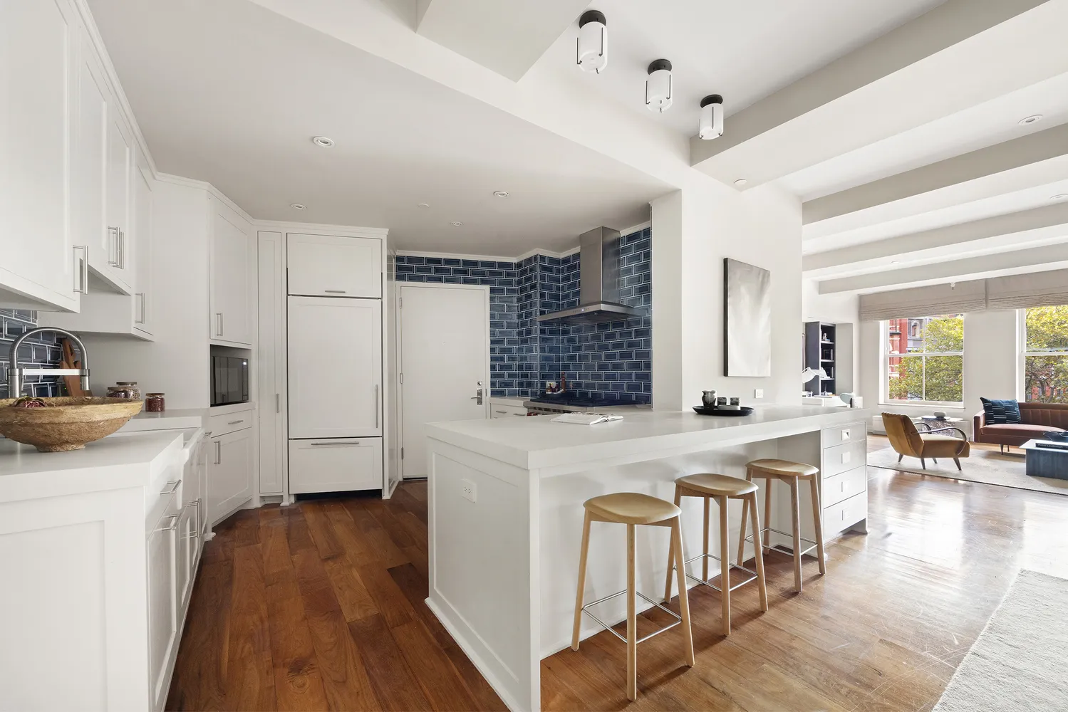 a kitchen with a stove a refrigerator a oven a sink dishwasher and white cabinets with wooden floor