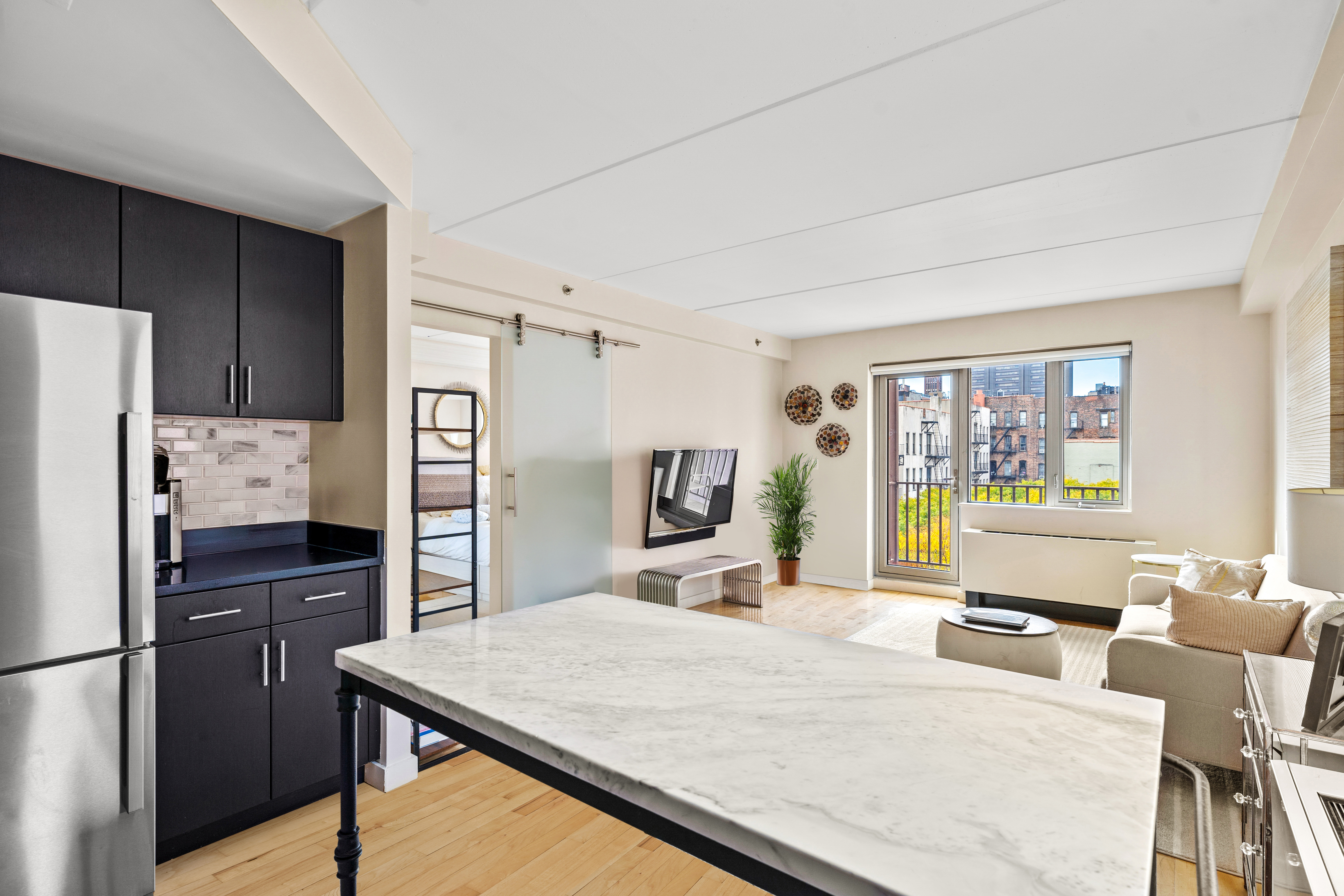 1810 3rd Avenue, Unit A9B Manhattan, NY 10029 - Photo 4 of 16 a kitchen with stainless steel appliances a refrigerator and a stove top oven