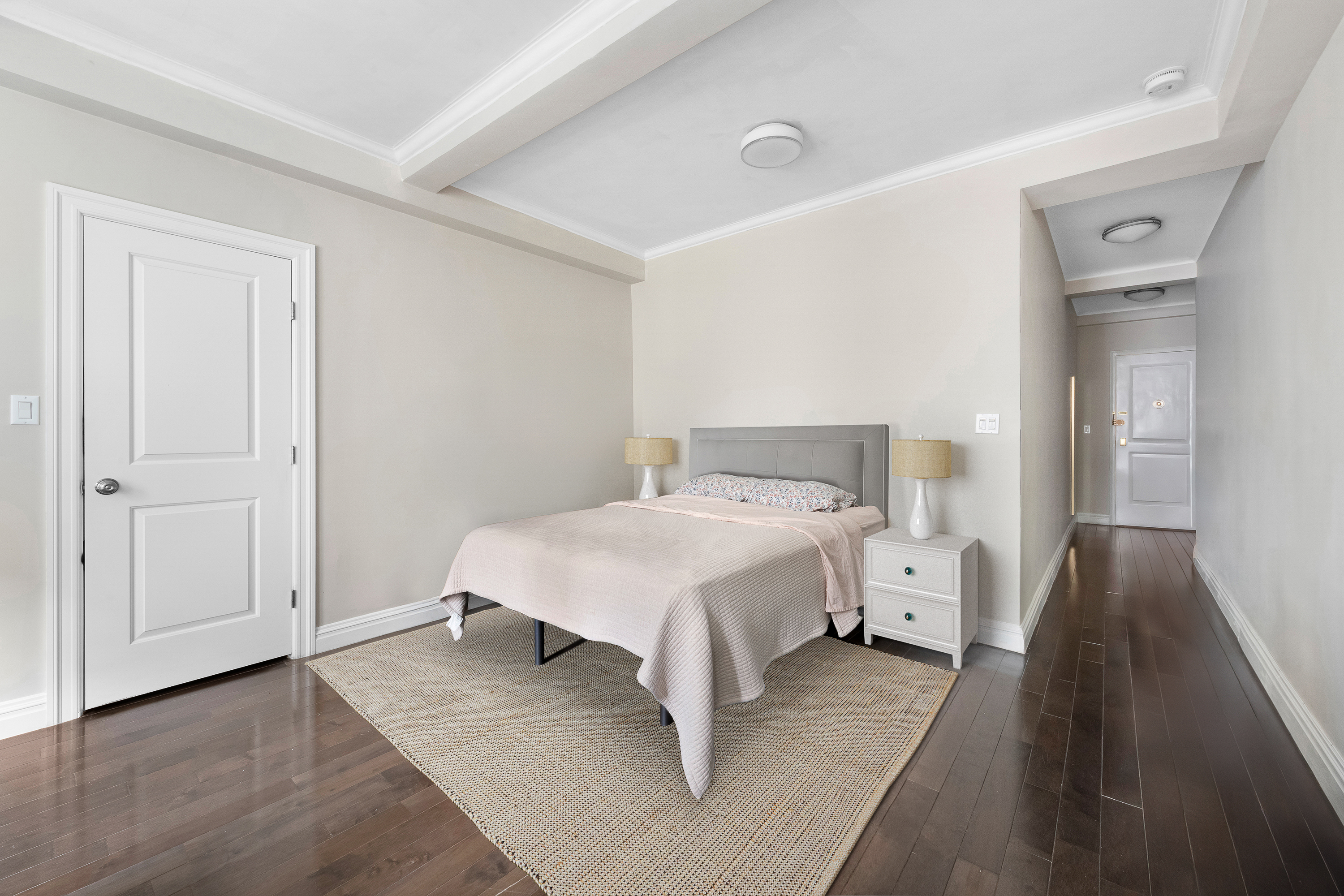 17 West 64th Street, Unit 4E Manhattan, NY 10023 - Photo 3 of 9 a bedroom with a bed and wooden floor