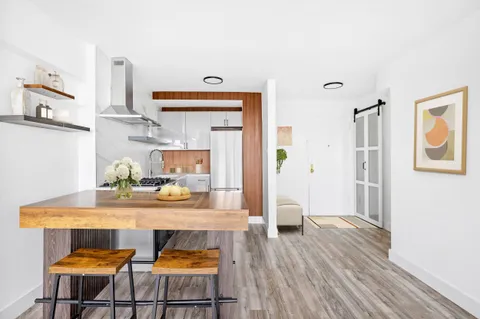 a kitchen with a table and chairs