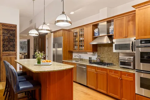 a kitchen with stainless steel appliances a sink stove and cabinets