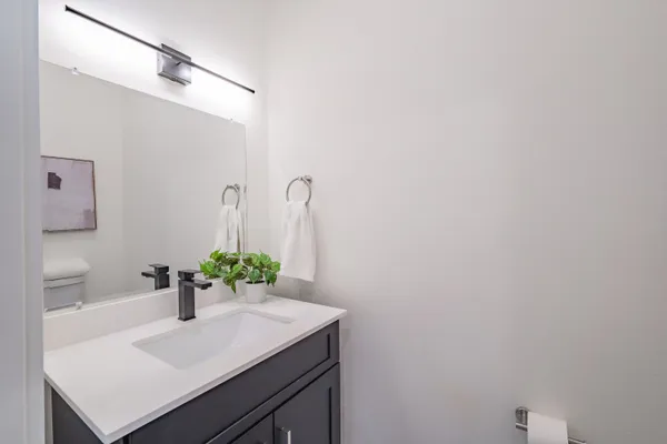 a spacious bathroom with a double vanity sink and a mirror