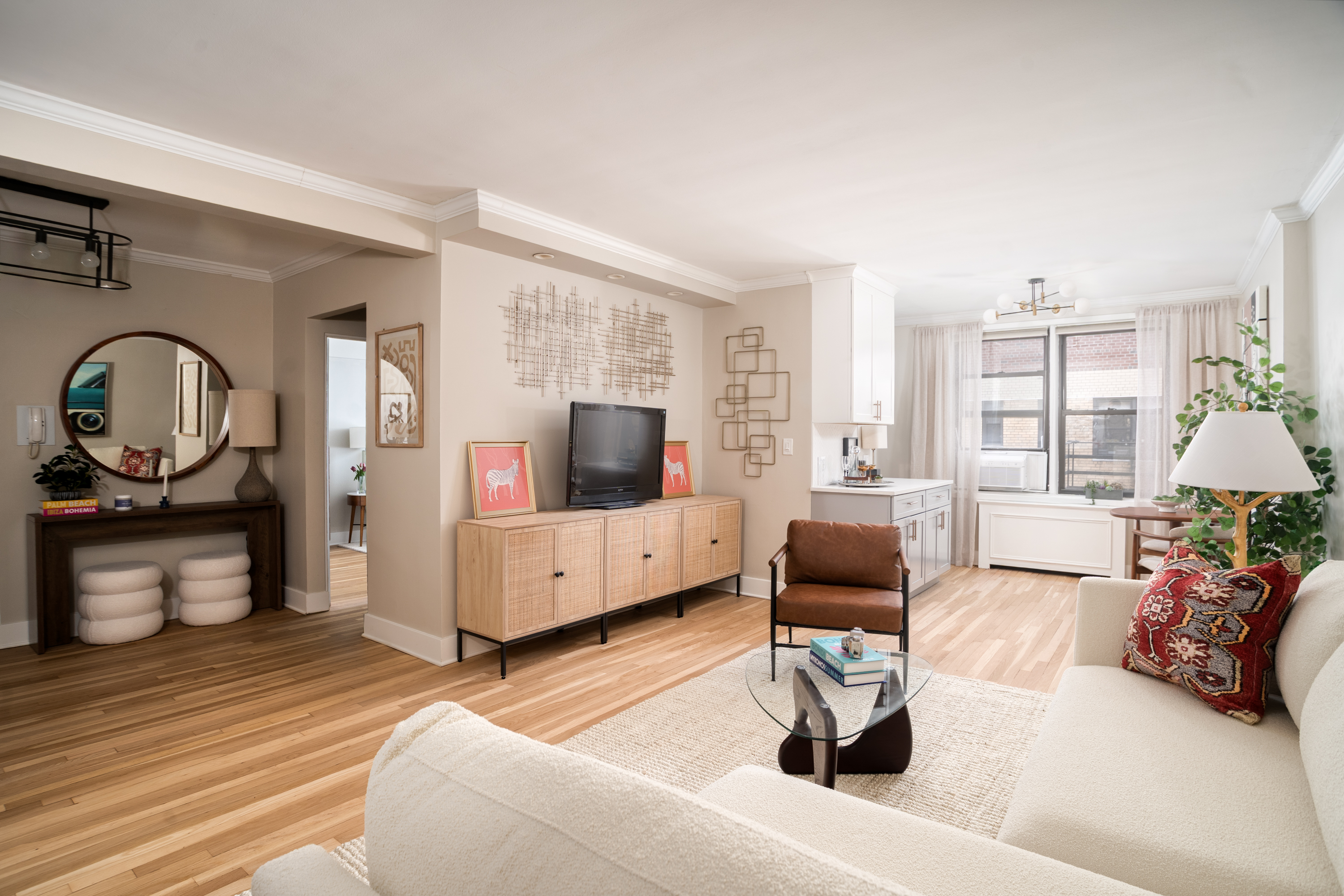 60 East 9th Street, Unit 640 Manhattan, NY 10003 - Photo 3 of 10 a living room with furniture and a flat screen tv