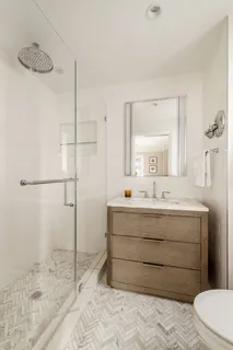 a bathroom with a sink mirror vanity and toilet