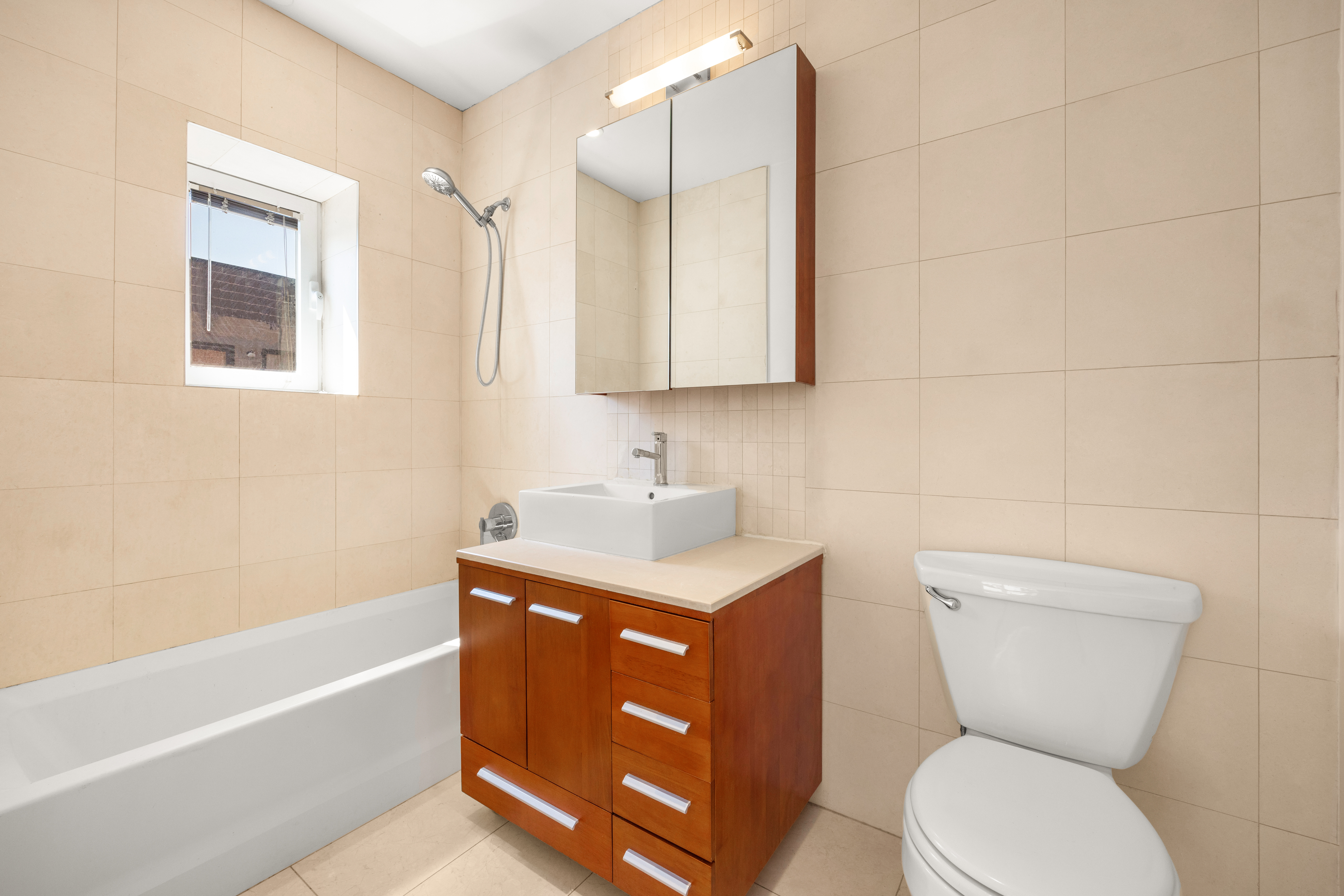 162 16th Street, Unit 7E Brooklyn, NY 11215 - Photo 7 of 23 a bathroom with a toilet sink and mirror